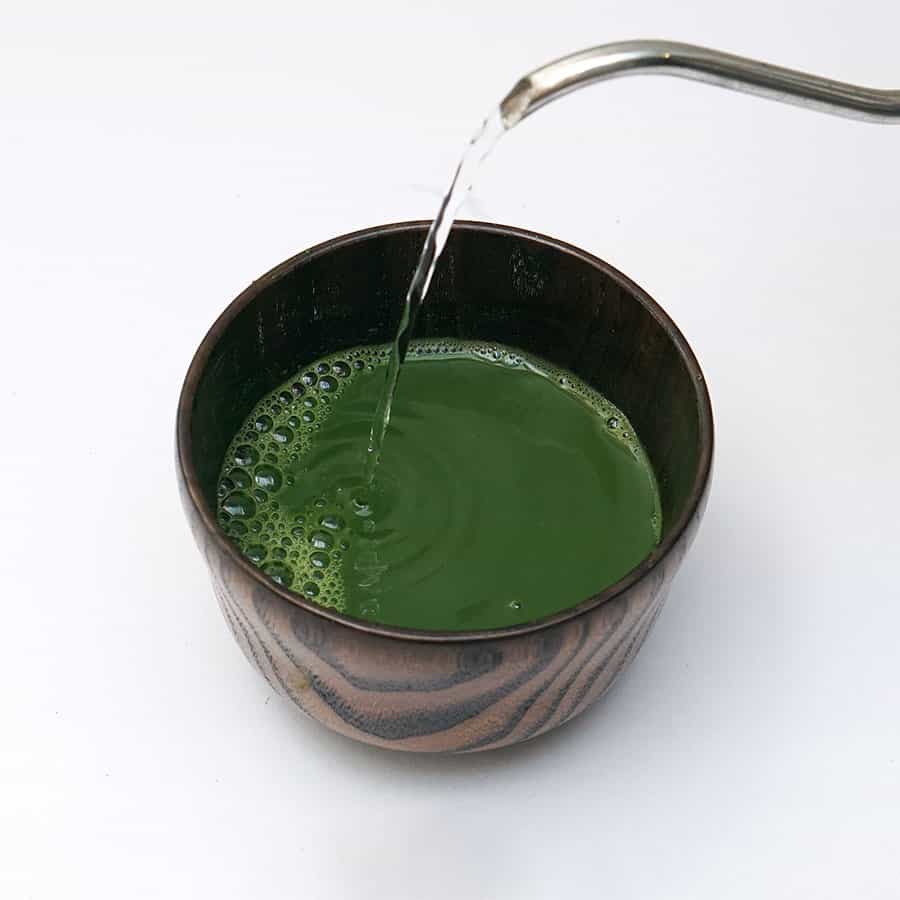 pouring water in matcha green tea powder